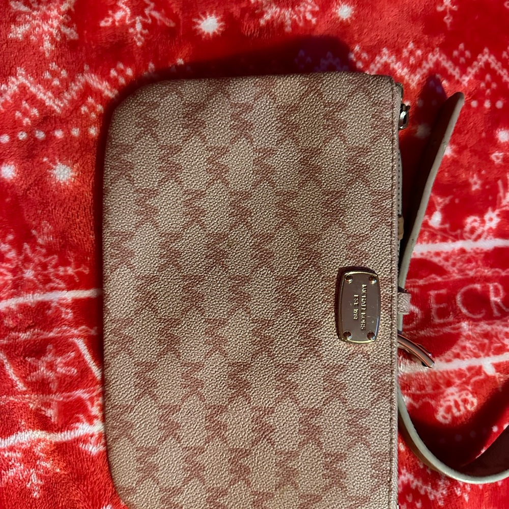 Pink wallet or mini purse it’s Michael Kors